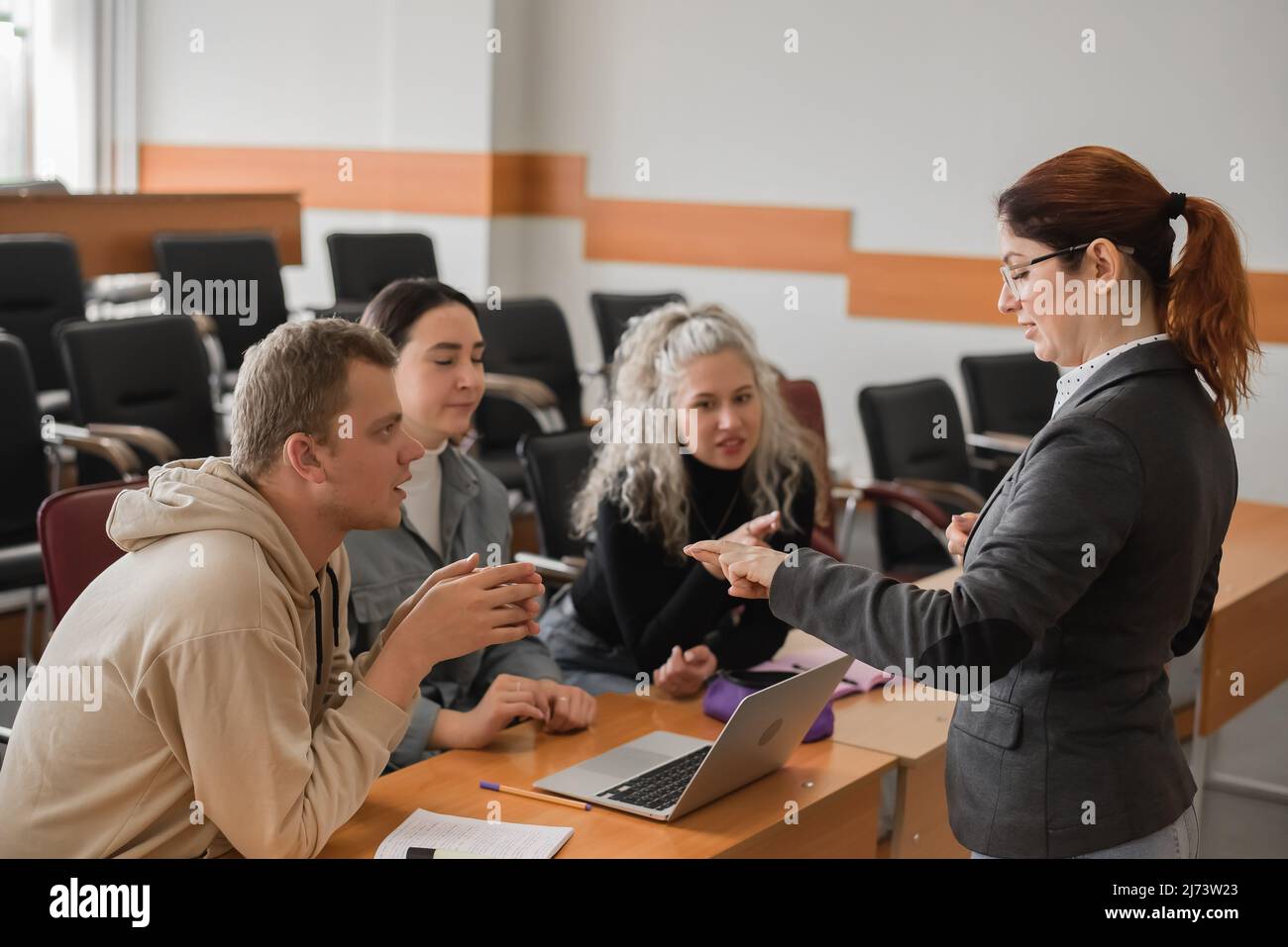 The teacher and students communicate in sign language in the classroom. Hearing impaired and