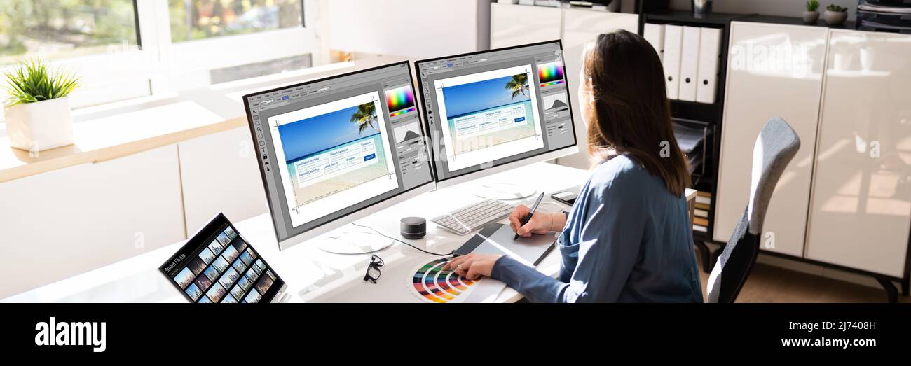Graphic Web Designer Using Multiple Monitors Desktop Computer Stock Photo