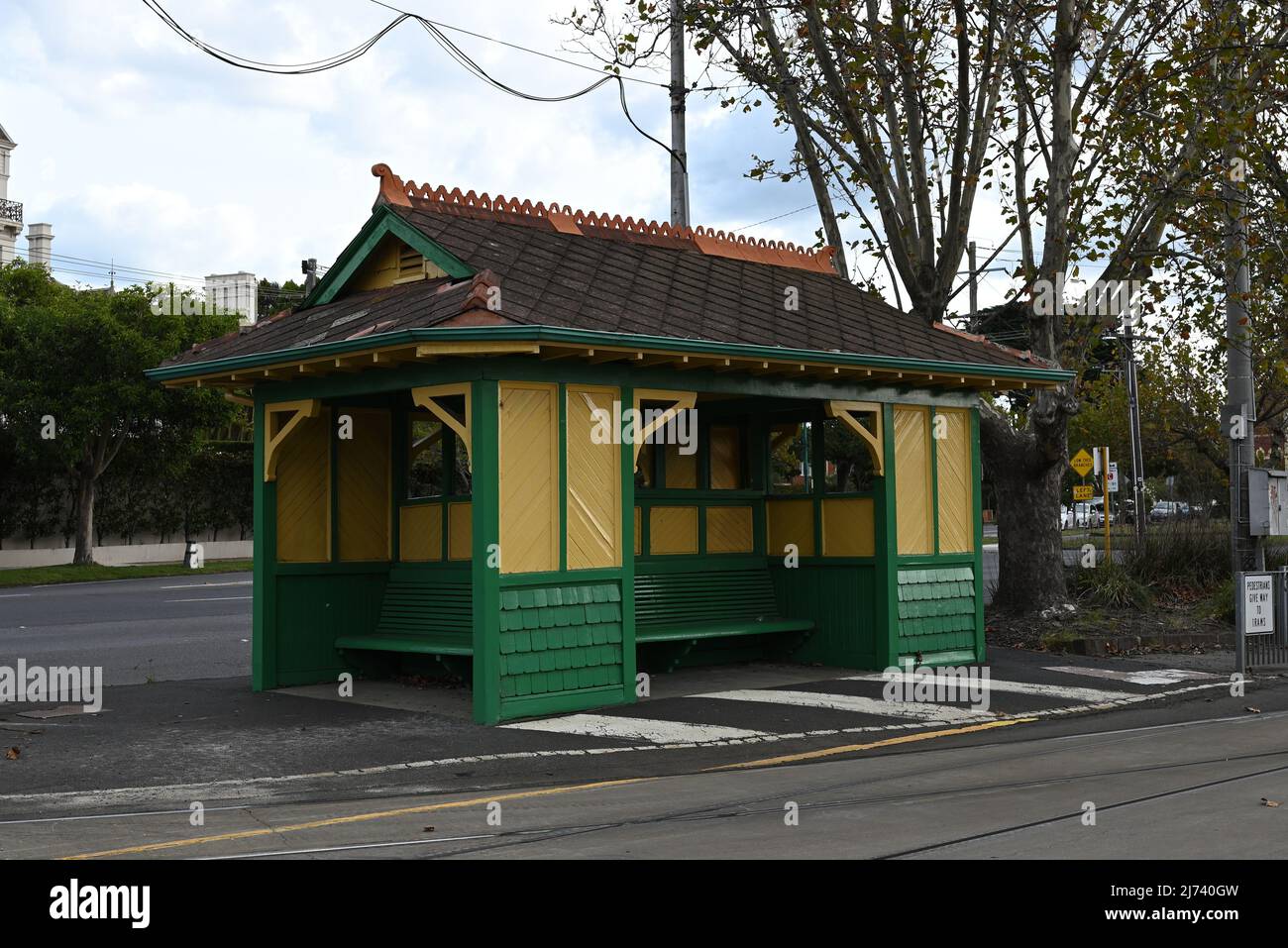 Old green and yellow painted wooden tram shelter at the corner of Hawthorn Rd and Dandenong Rd Stock Photo