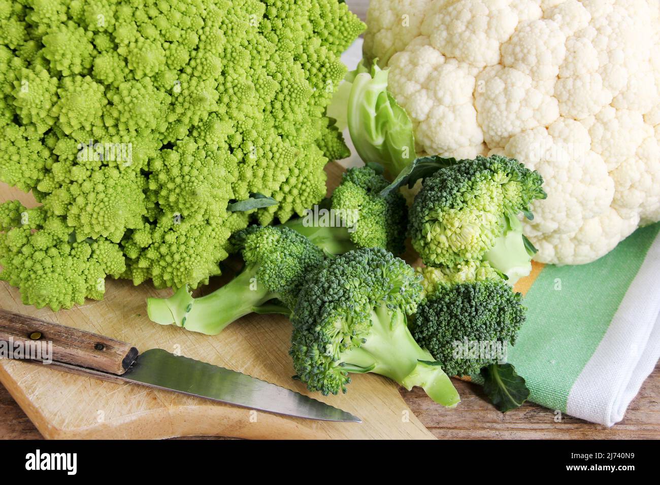 Three cruciferae family vegetables romanesque, broccoli and cauliflower Stock Photo Alamy