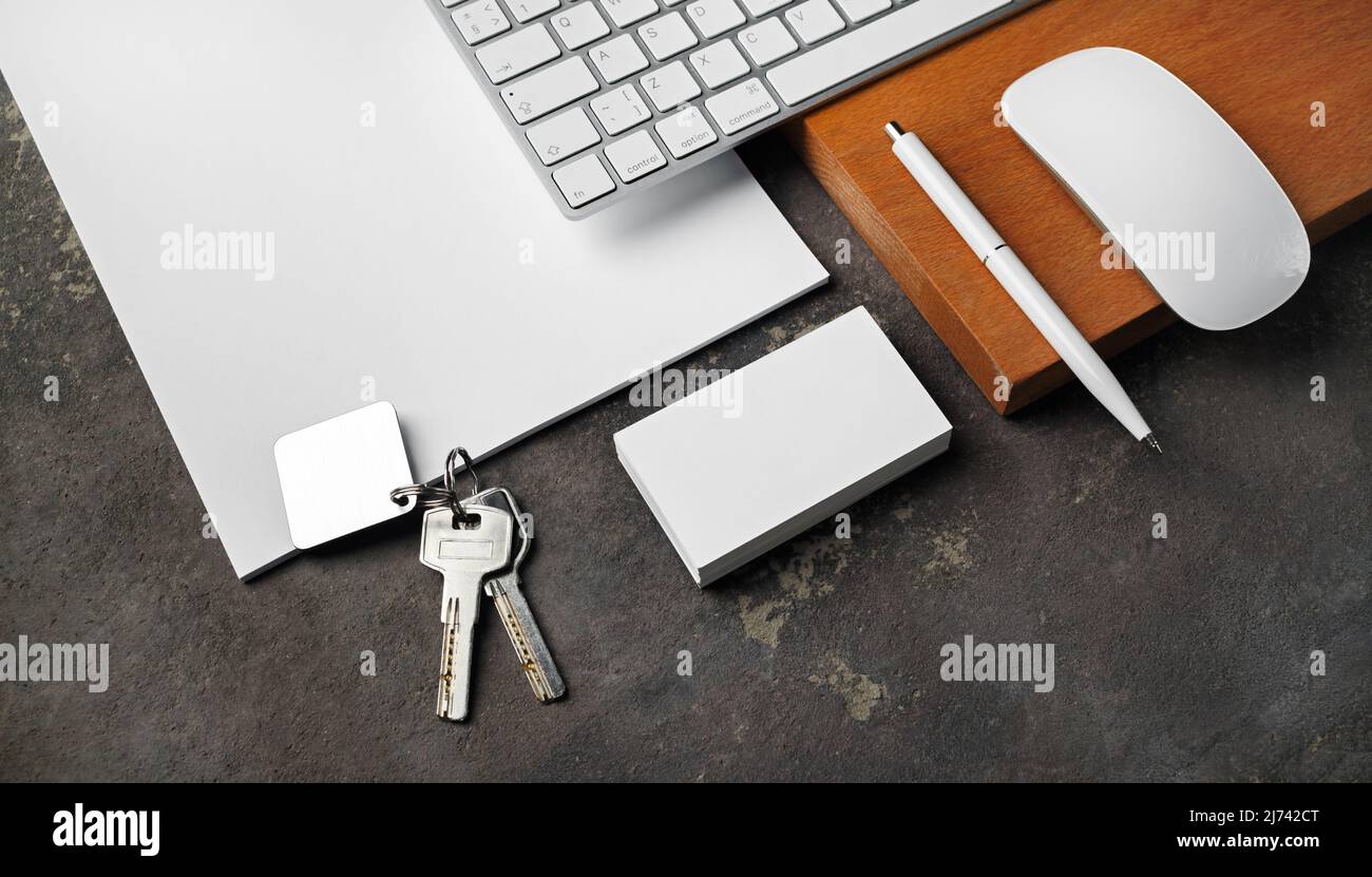 Blank stationery, keys and gadgets. Real estate agency concept. Stock Photo