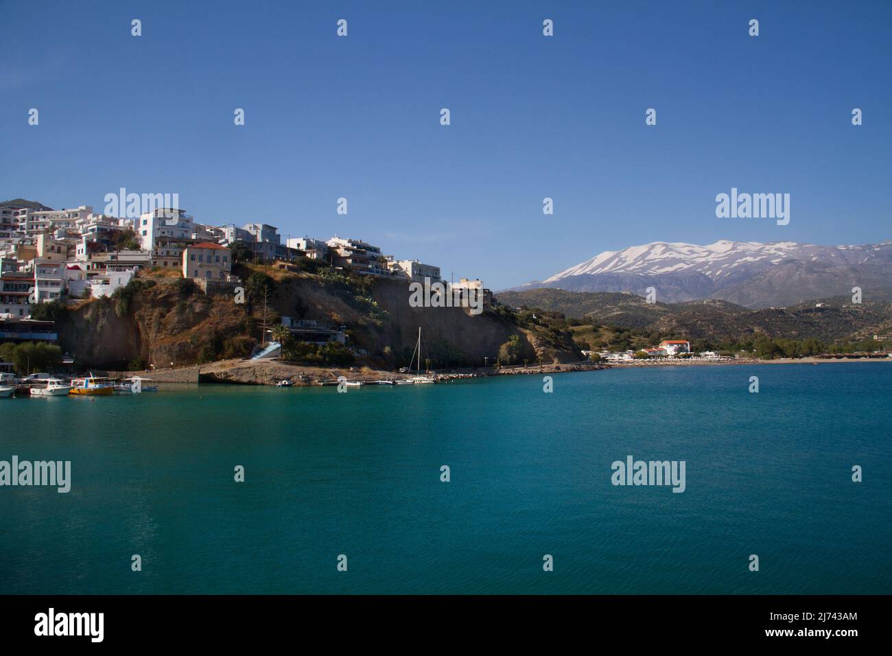 Agia Galini, picturesque mediterranean village, in the background the show covered mountain, Ida Psiloritis Stock Photo
