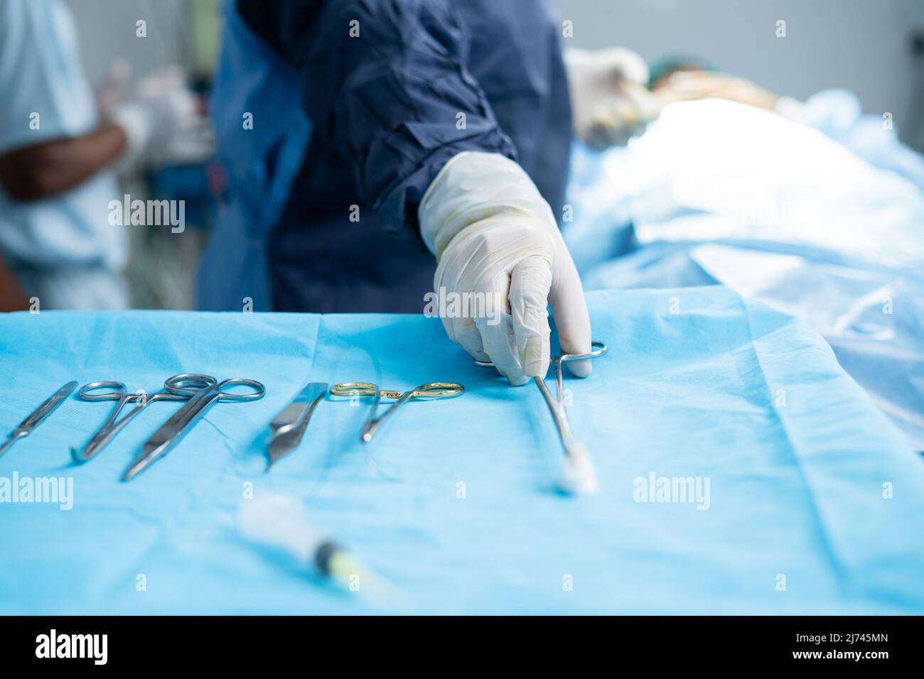Close up shot of surgeons using medical equipment for surgery at operation theatre - concept of treatment, responsibility and professional occupation. Stock Photo