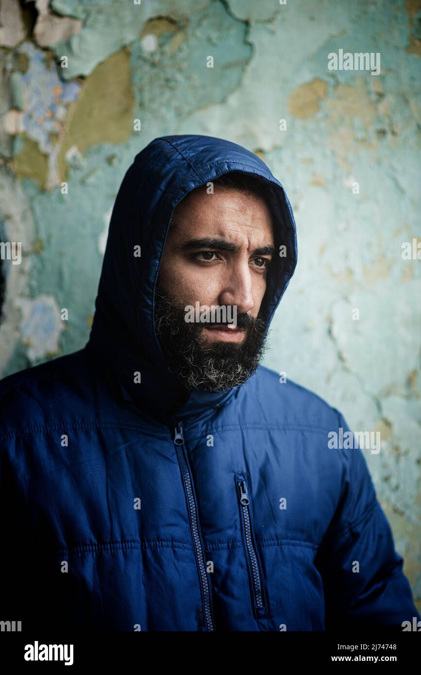 Bearded middle eastern man wearing hooded jacket Stock Photo