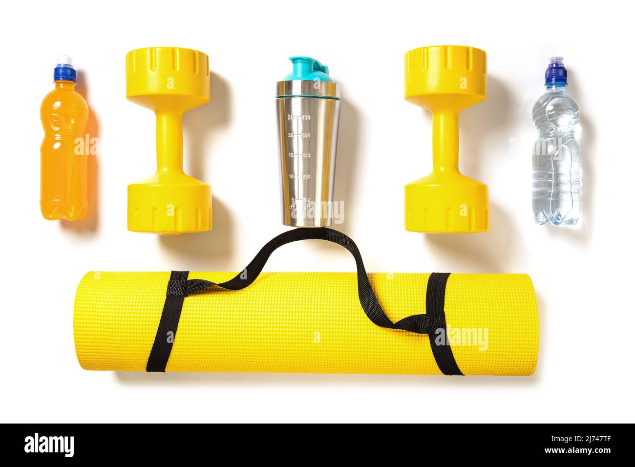 Yellow dumbbells, fitness mat and different sports drinks and nutrition