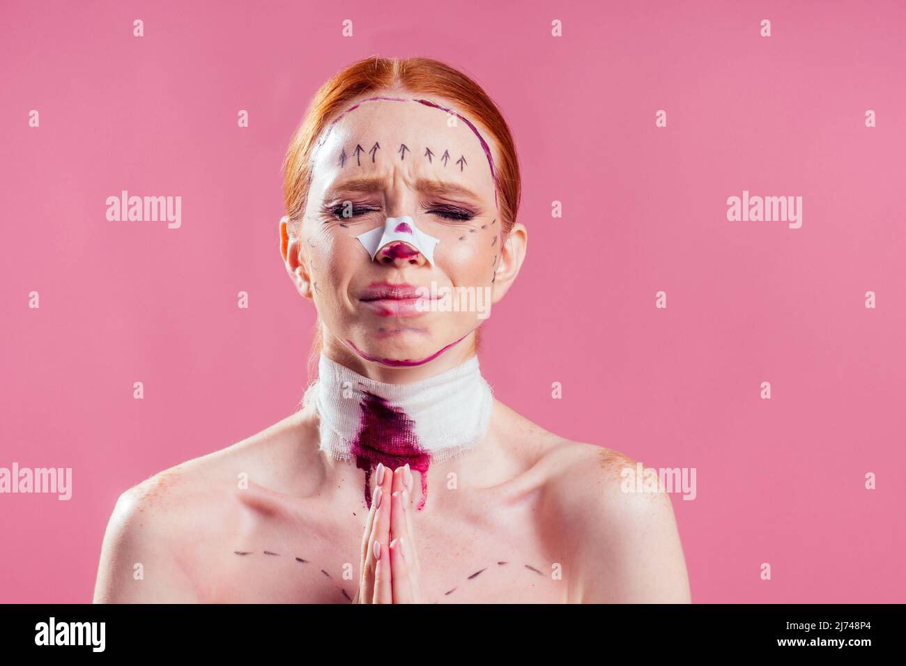 caucasian panic female cosmetic lifting procedure in studio pink background Stock Photo