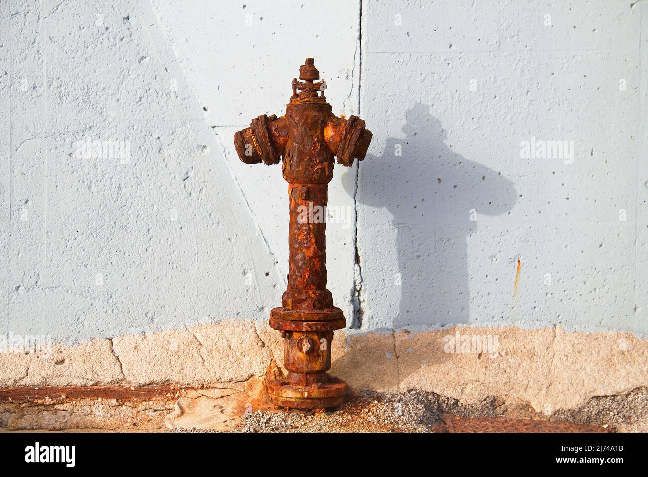 Old and very rusty fire hydrant, deferred maintenance Stock Photo