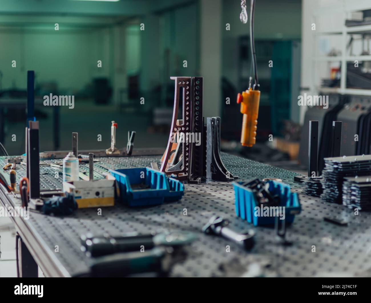 A smart factory worker or engineer makes machines in a production