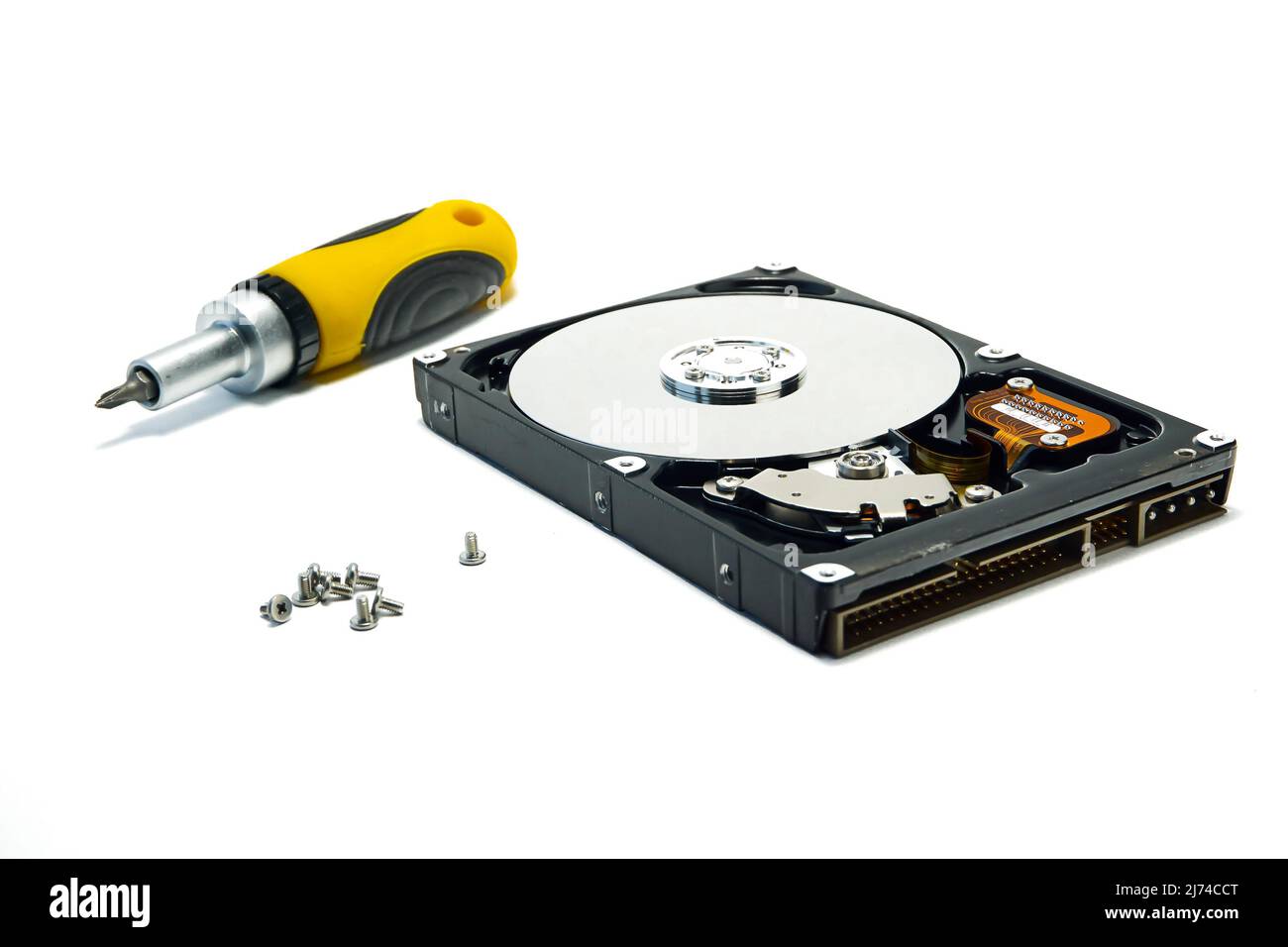 Open hard drive and screwdriver isolated on white background closeup