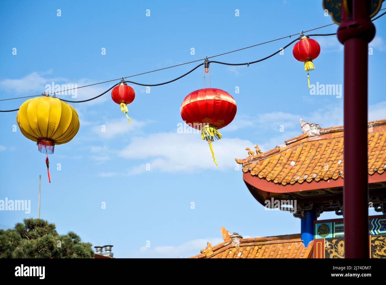 Hanging Chinese lanterns against the blue sky in Chinatown in Victoria, BC, Canada. Stock Photo