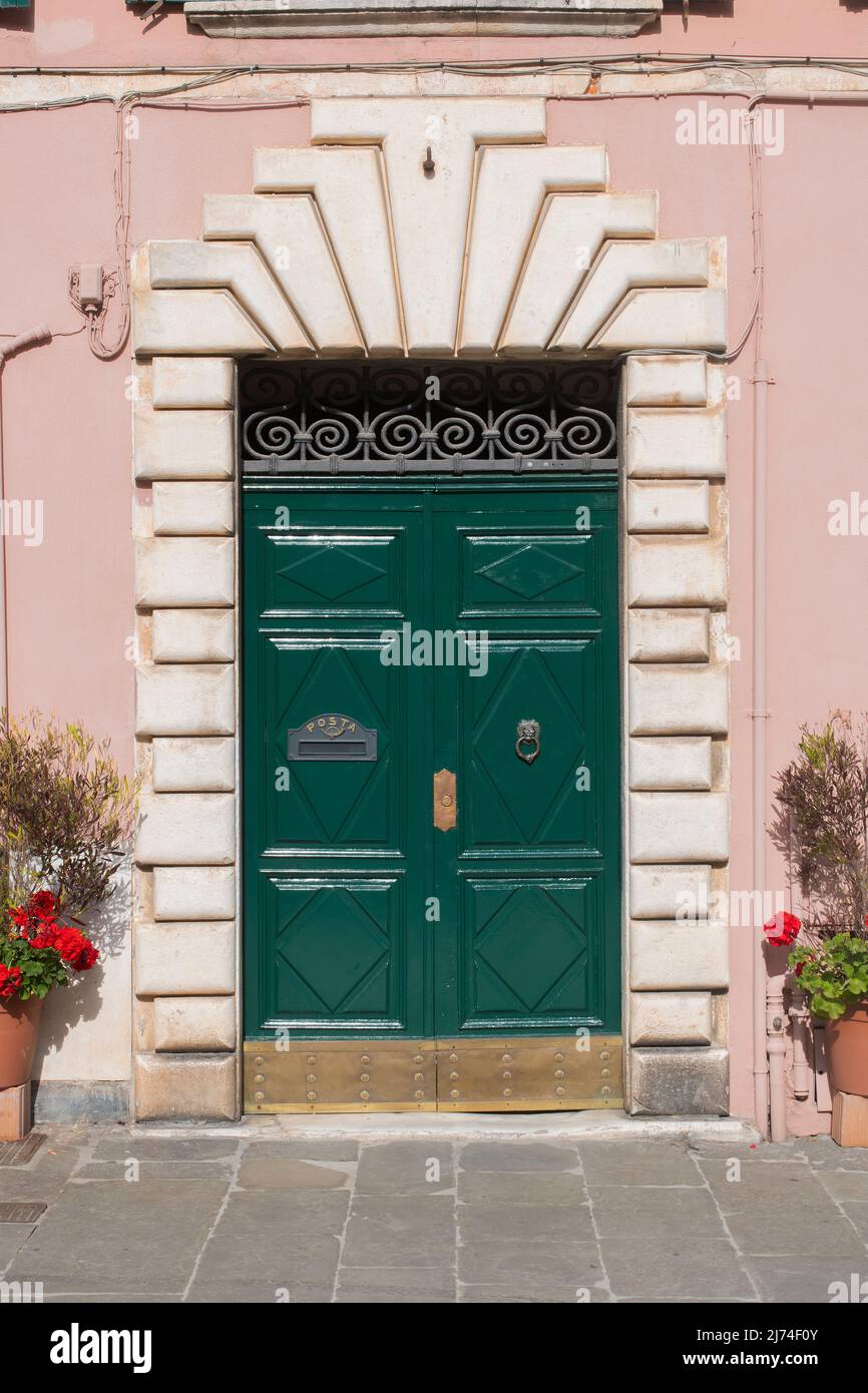 Wooden door with marble portal and letterbox on an Italian building Stock Photo
