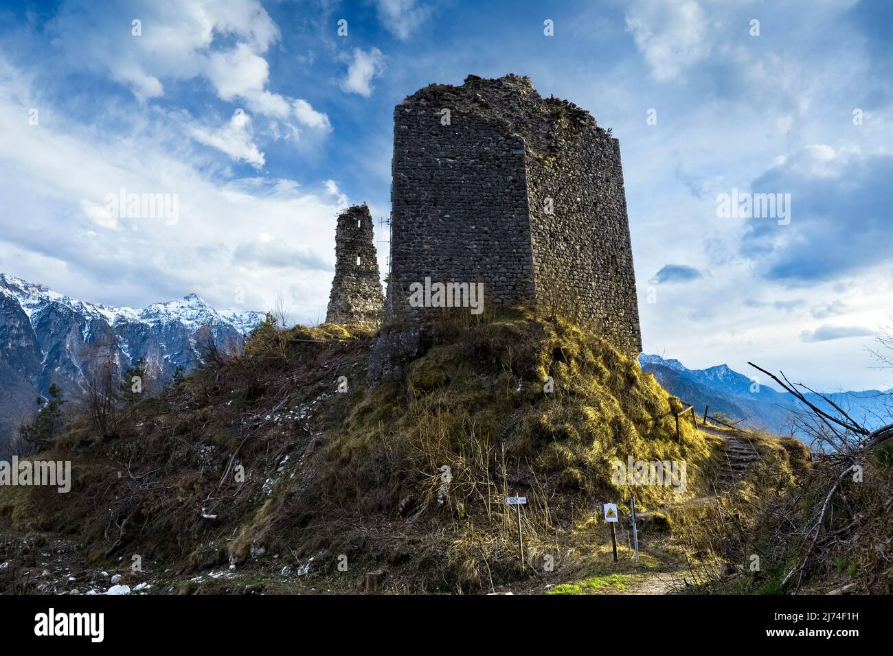 The medieval ruins of San Pietro castle stand out on the top of Mount Ciolino. Torcegno, Valsugana, Trento province, Trentino Alto-Adige, Italy. Stock Photo
