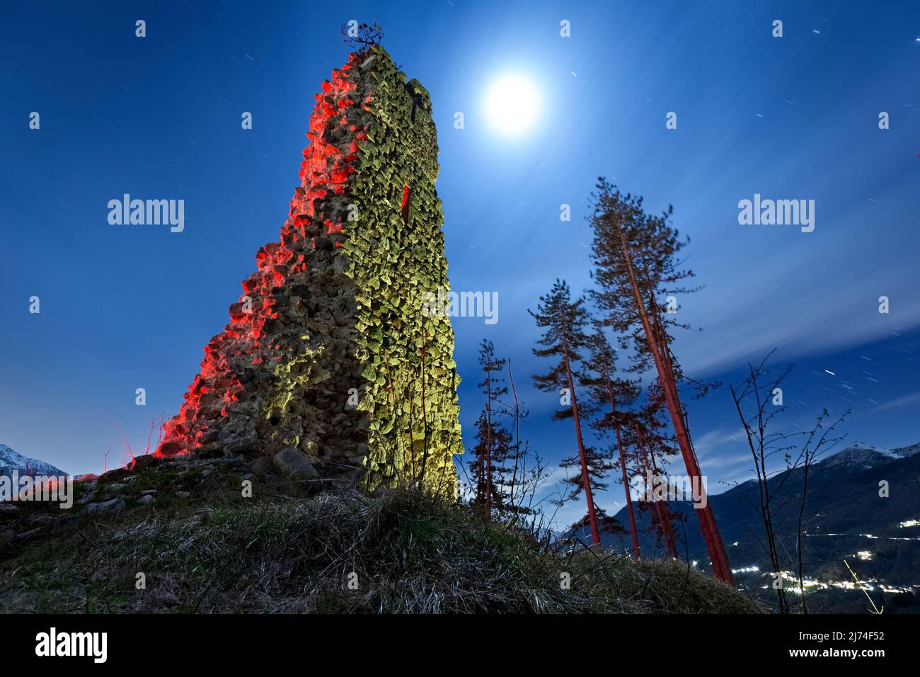 Ghostly night at the medieval ruins of San Pietro castle in Torcegno. Valsugana, Trento province, Trentino Alto-Adige, Italy, Europe. Stock Photo