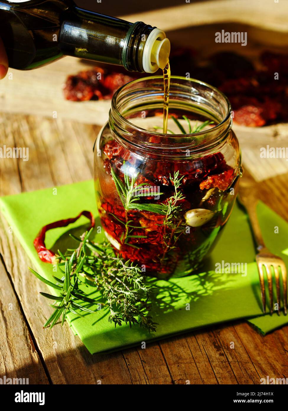 filling native olive oil in a jar; situation shows how to preserve