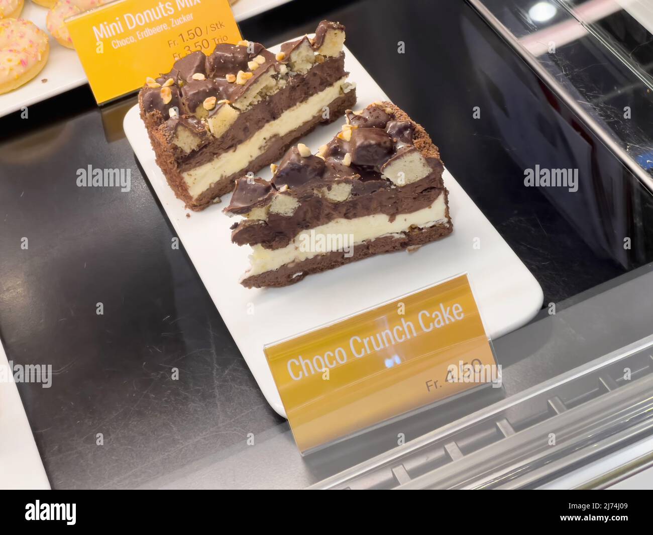 Basel, Switzerland - Dec 20, 2021: Close-up POV shot of delicious McDonalds Choco Crunch Cake with the high price of 4, 5 swiss francs Stock Photo