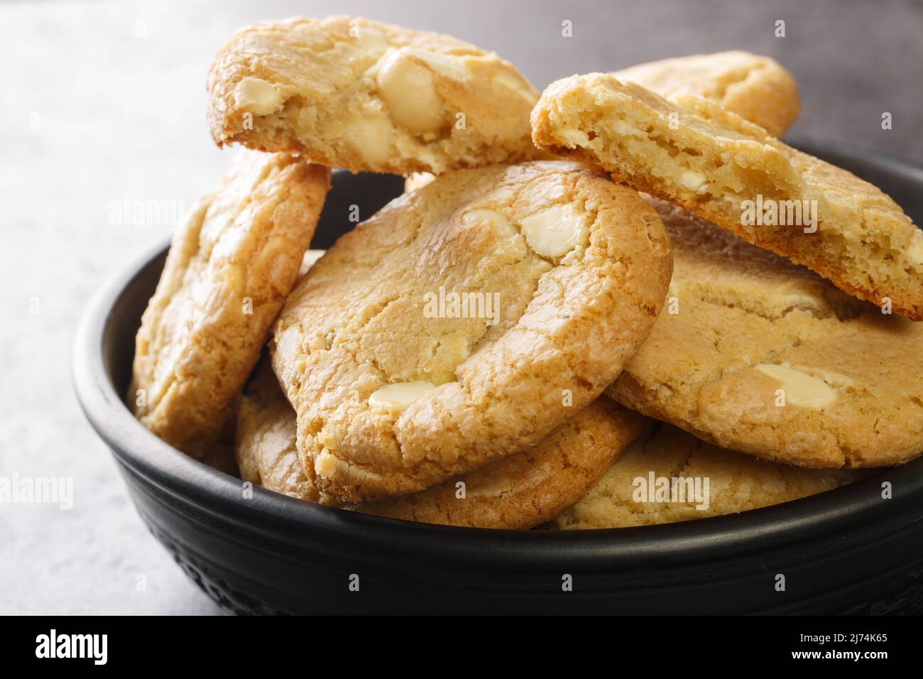 Homebaked white chocolate chip cookies with macadamia nuts on the table close-up. Horizontal Stock Photo