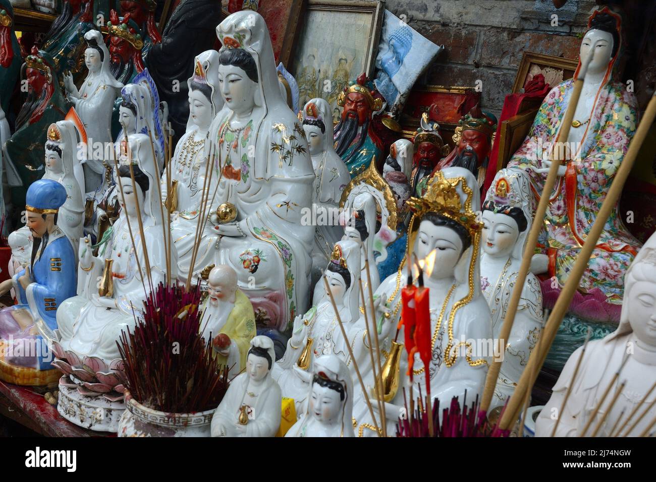 Adoration figures with joss sticks on a small altar on a street in Kowloon, China, Hong Kong Stock Photo
