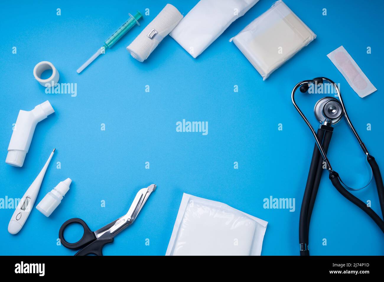 First Aid Kit With Medical Equipment On Blue Background Stock Photo - Alamy