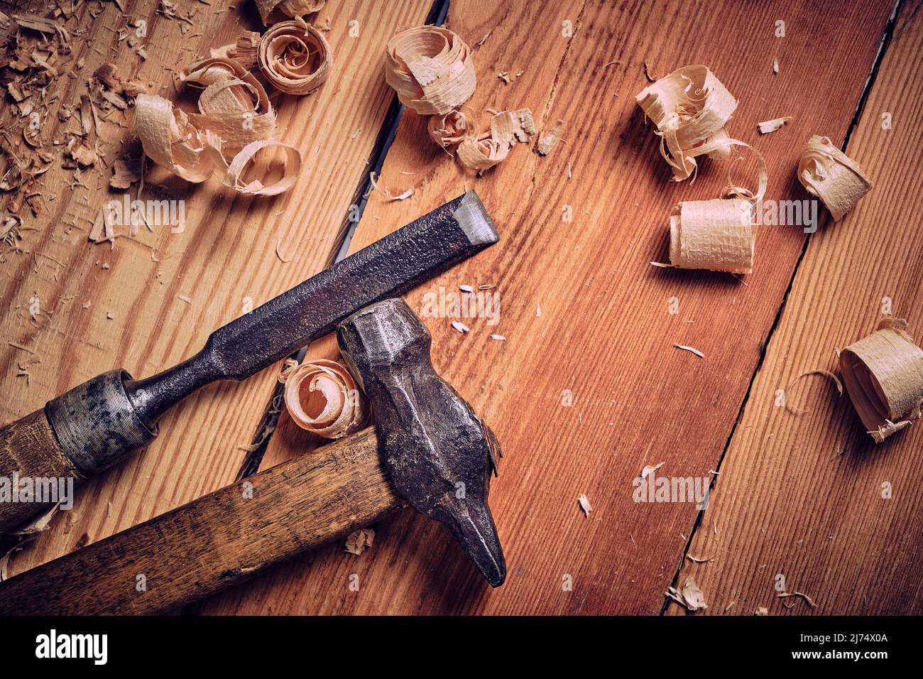 Hammer and chisel carpenter tool on wooden background Stock Photo