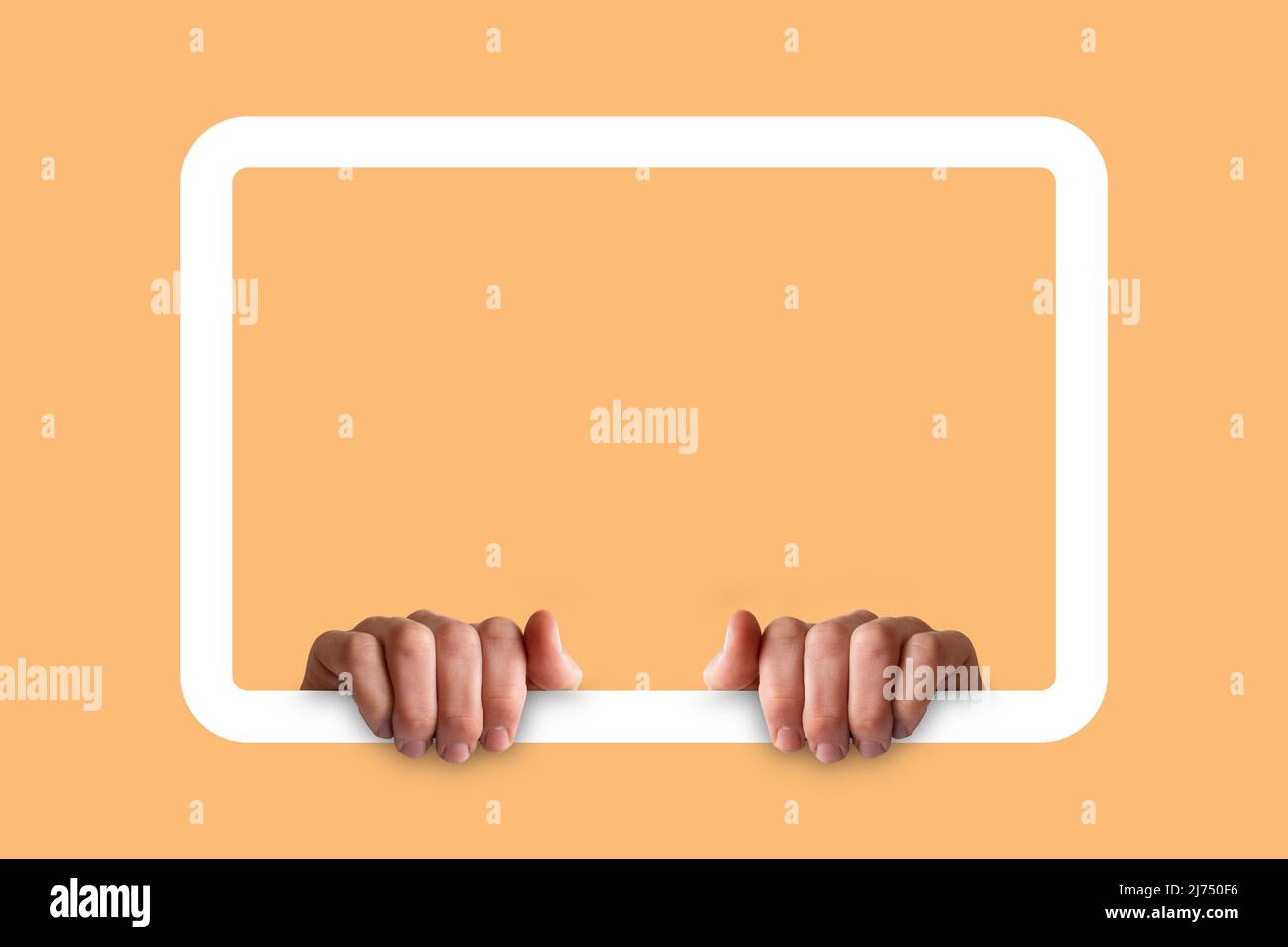 Hands holding a white frame, isolated on tan color background, copy space for faces and texts, two hands and frame, mockup concept, blank area Stock Photo