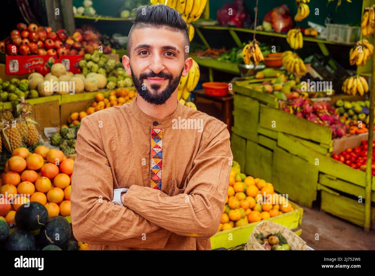 arabian man offering a pineapple on the street in goa Stock Photo