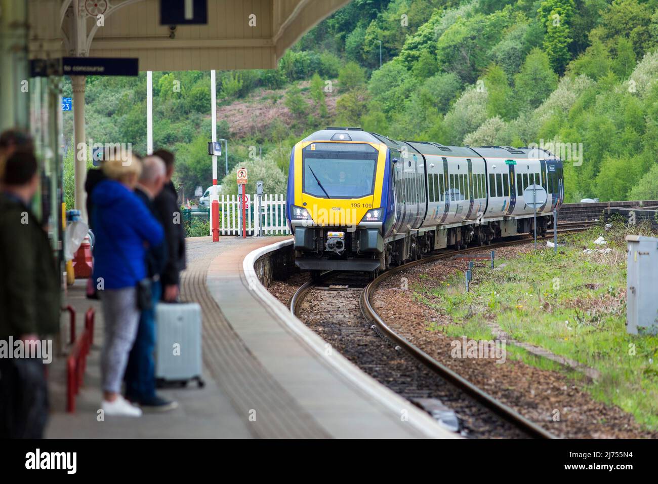 Halifax railway station serves the town of Halifax in West Yorkshire, England. It lies on the Calder Valley line and is 17 miles (27 km) west from Leeds.  Platform 2 heads eastbound, towards Bradford and Leeds, while platform 1 heads westbound towards Brighouse, Huddersfield, Sowerby Bridge, Blackpool North and Manchester Victoria. The two routes divide about a mile south of the station at Dryclough Junction.  Credit: Windmill Images/Alamy Stock Photo