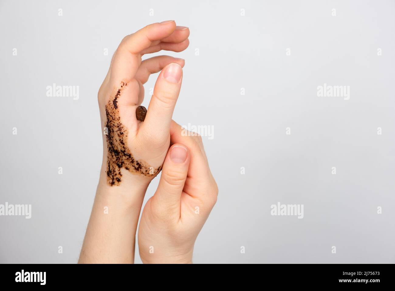 Coffee scrub on women's hands, body and hand skin care, scrubbing and pilling, a place for text Stock Photo