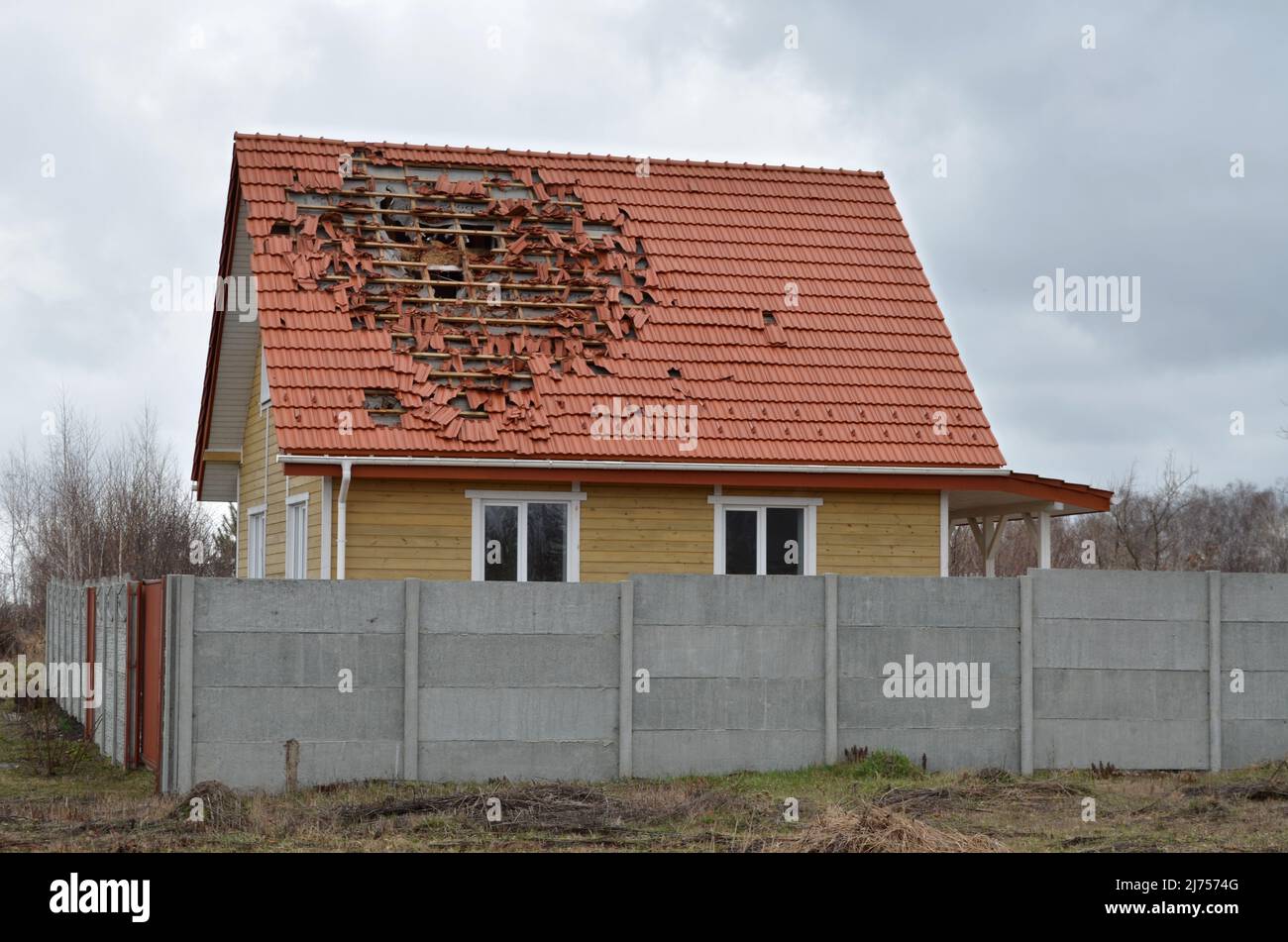 Dmytrivka village, Kyiv region, Ukraine - Apr 03, 2022: Damaged house roof by the russian occupiers in the result of shelling. Stock Photo