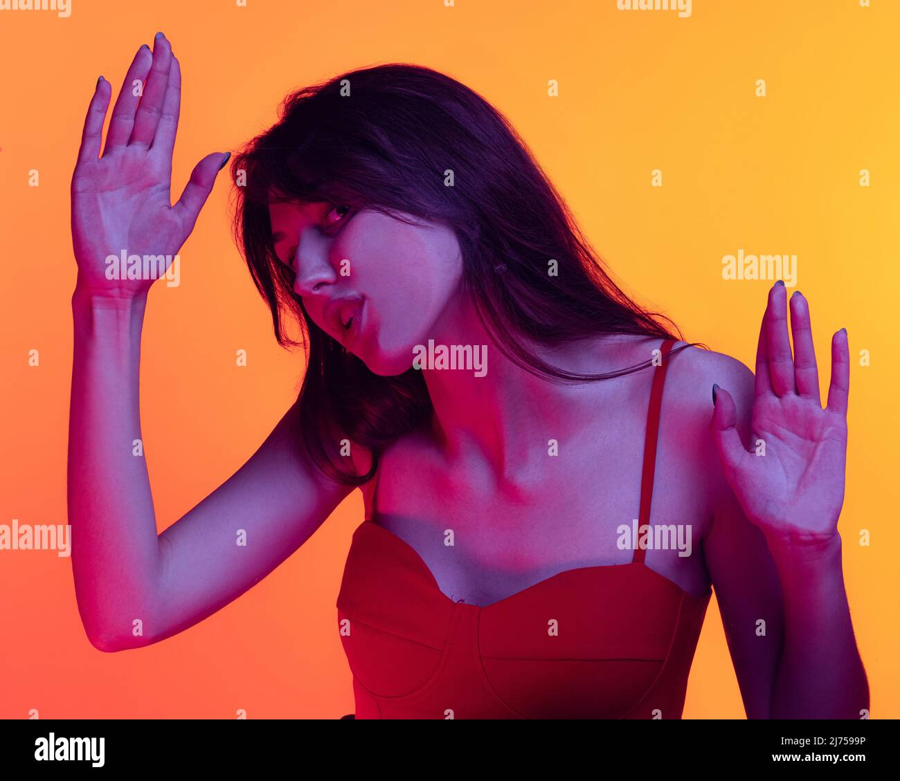 Young funny girl, student leaned against transparent glass isolated on