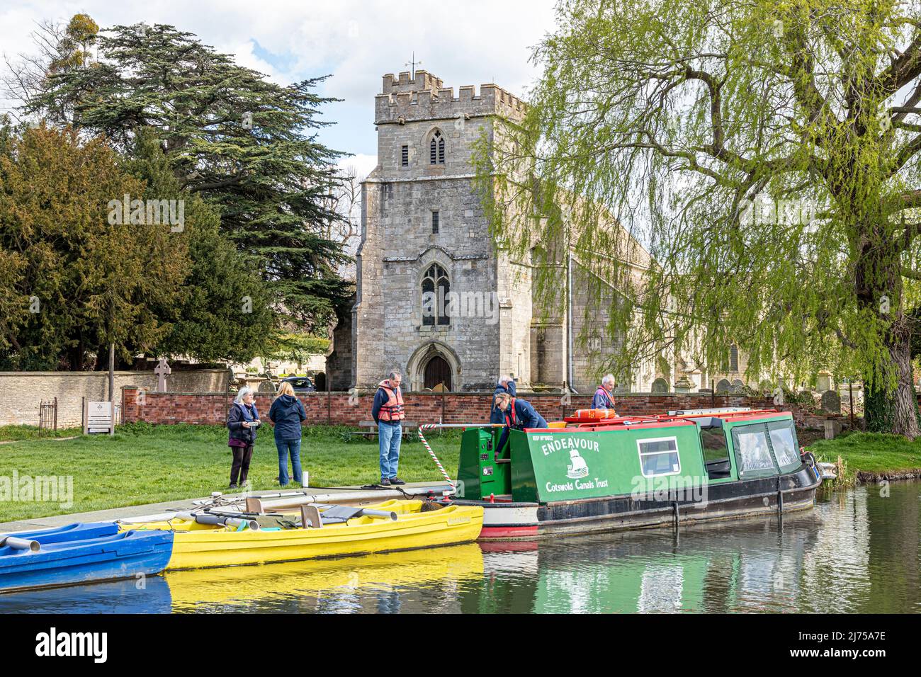 The Cotswold Canals Trust long boat Endeavour on the restored Stroudwater Canal at St Cyr's Church, Stonehouse, Gloucestershire, England UK Stock Photo