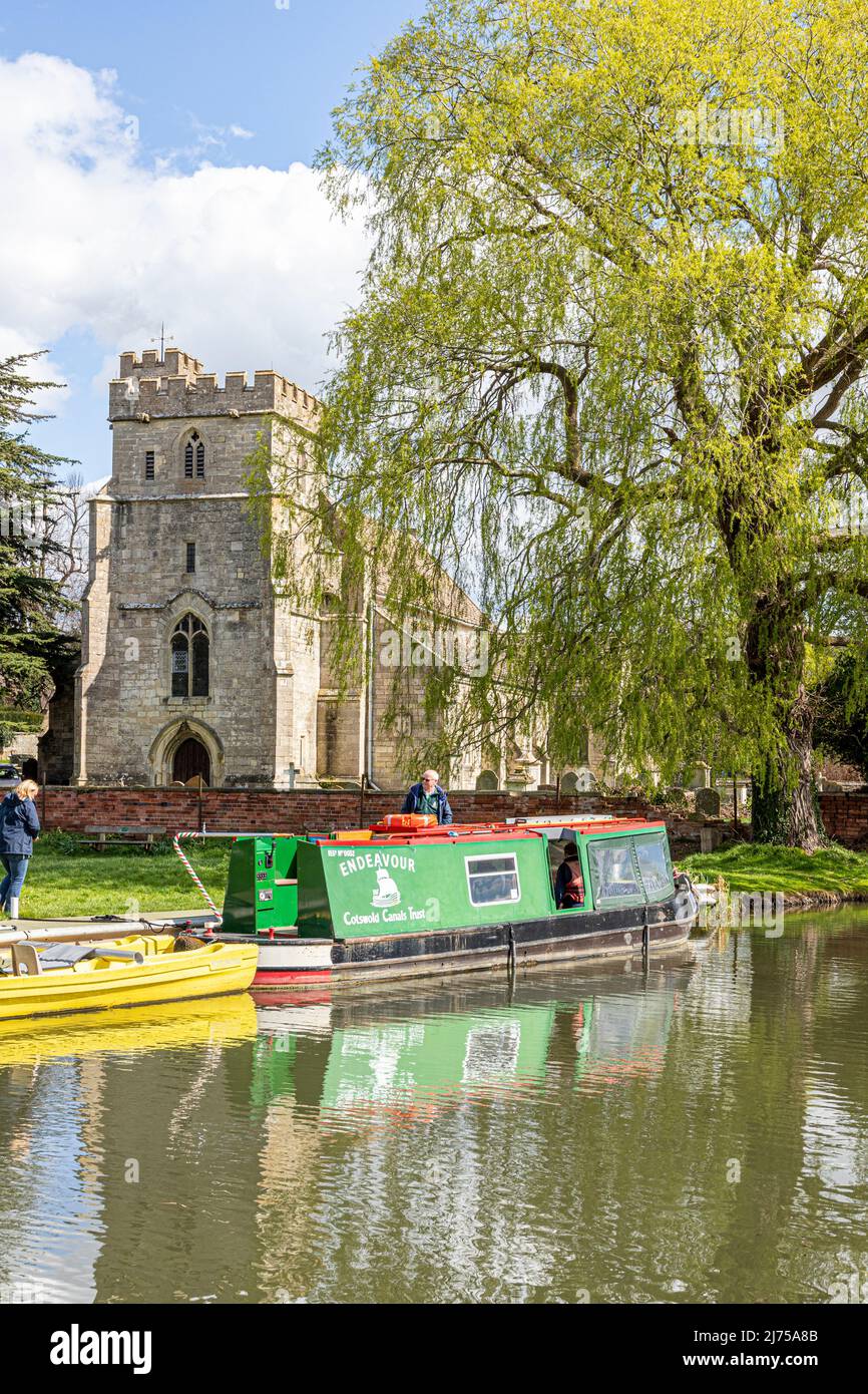 The Cotswold Canals Trust long boat Endeavour on the restored Stroudwater Canal at St Cyr's Church, Stonehouse, Gloucestershire, England UK Stock Photo
