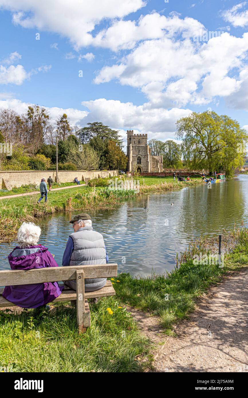 An older couple enjoying the view of the restored Stroudwater Canal at St Cyr's Church, Stonehouse, Gloucestershire, England UK Stock Photo