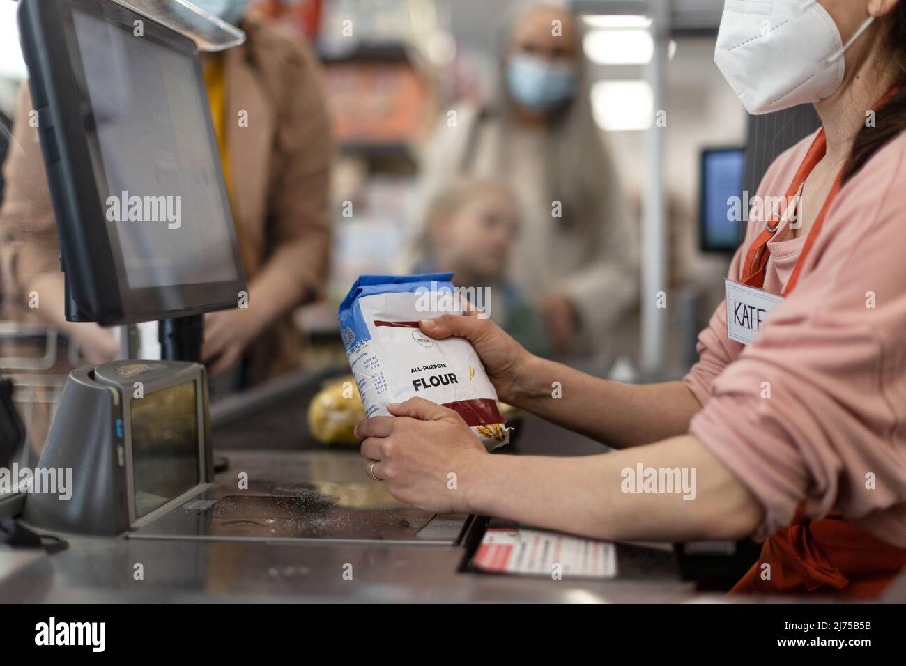 Checkout counter hands of the cashier scans groceries in supermarket. Stock Photo