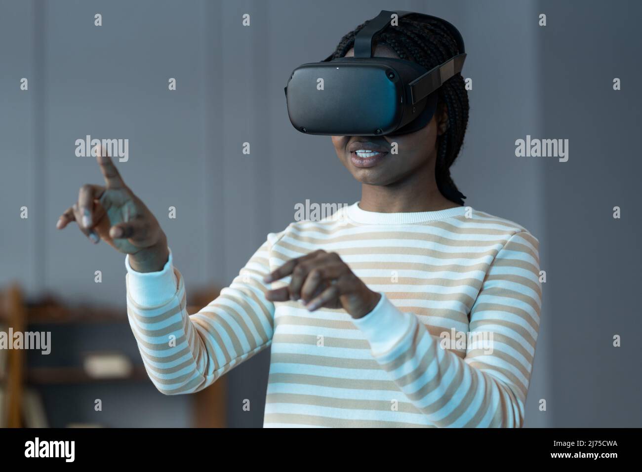 Black girl in virtual reality glasses feeling excited and amazed