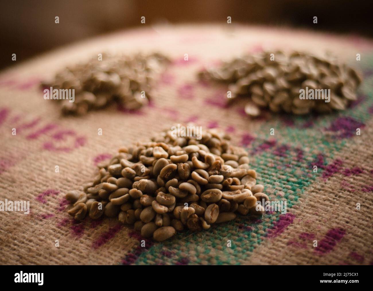 un-roasted coffee beans sitting on a burlap sack Stock Photo - Alamy