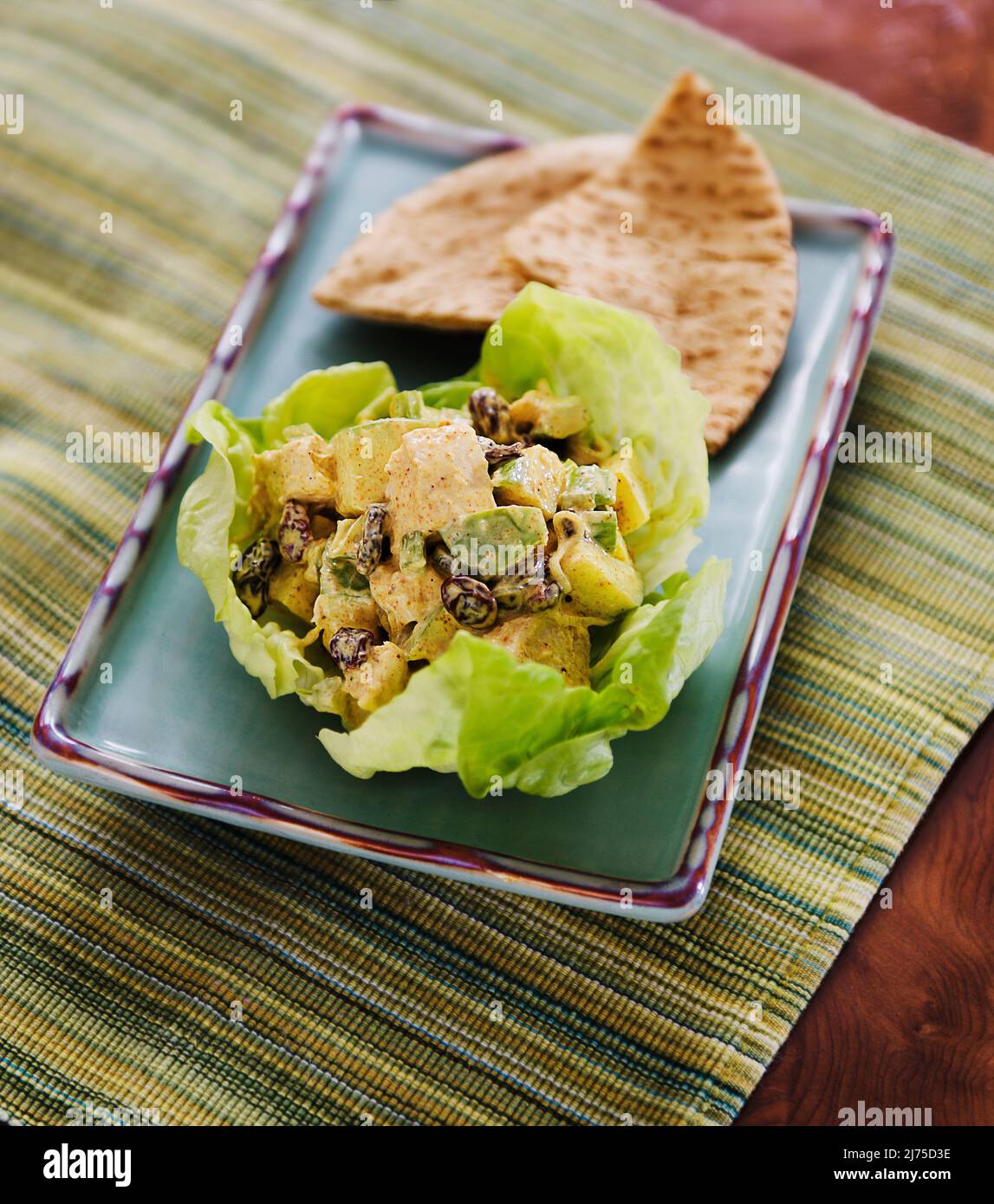 Chicken curry with raisins, apple and celery served in a lettuce leaf