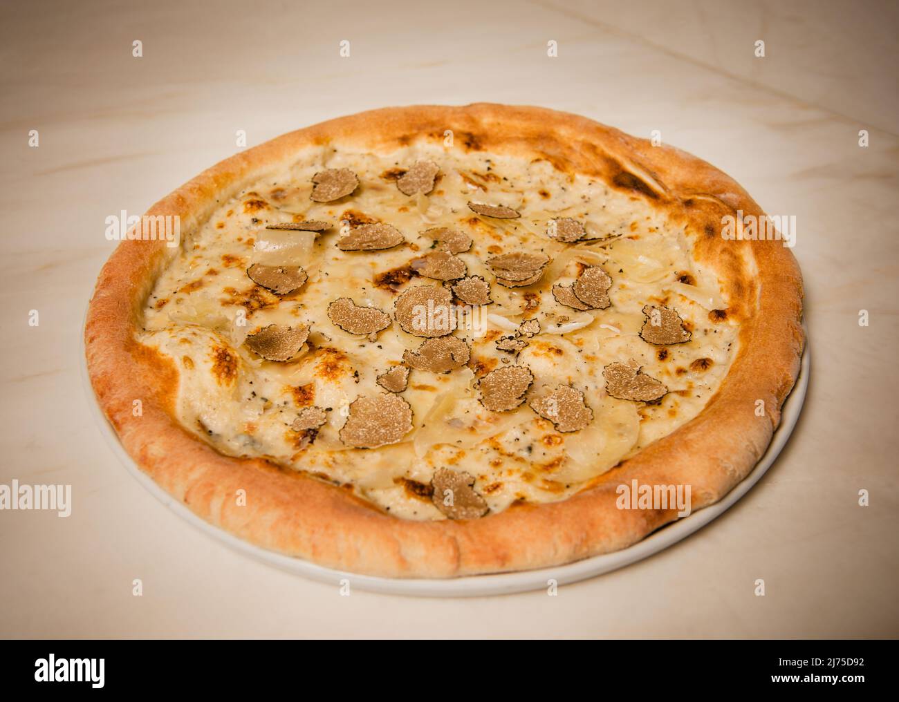 Black truffle pizza with béchamel sauce and italian cheeses Stock Photo