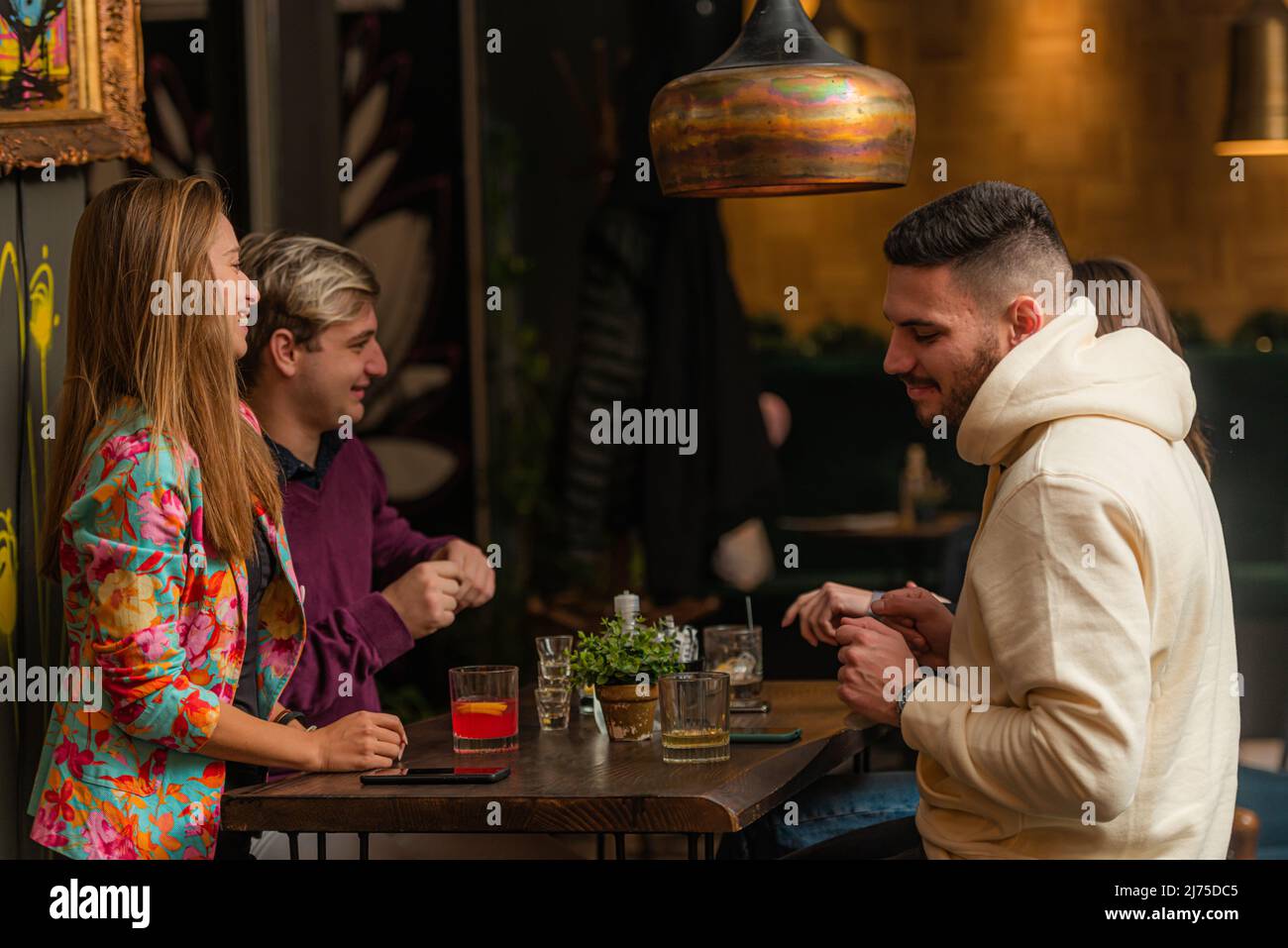 Two amazing and attractive couples are dancing together in the bar ...
