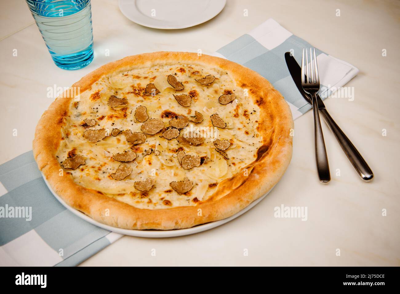Black truffle pizza with béchamel sauce and italian cheeses Stock Photo
