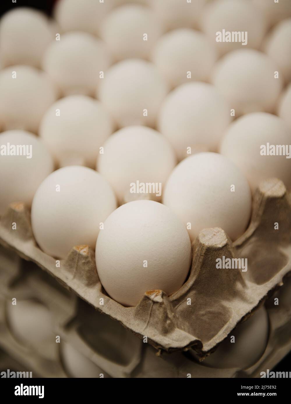 crates of eggs stacked in an industrial kitchen Stock Photo