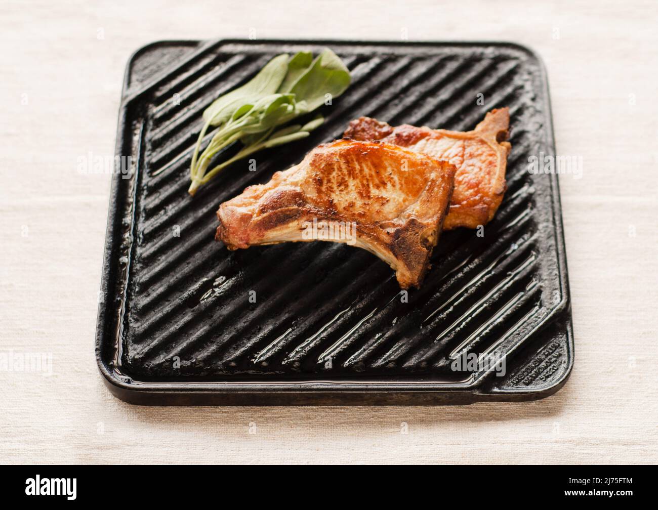 Pork chop on a grilling pan Stock Photo