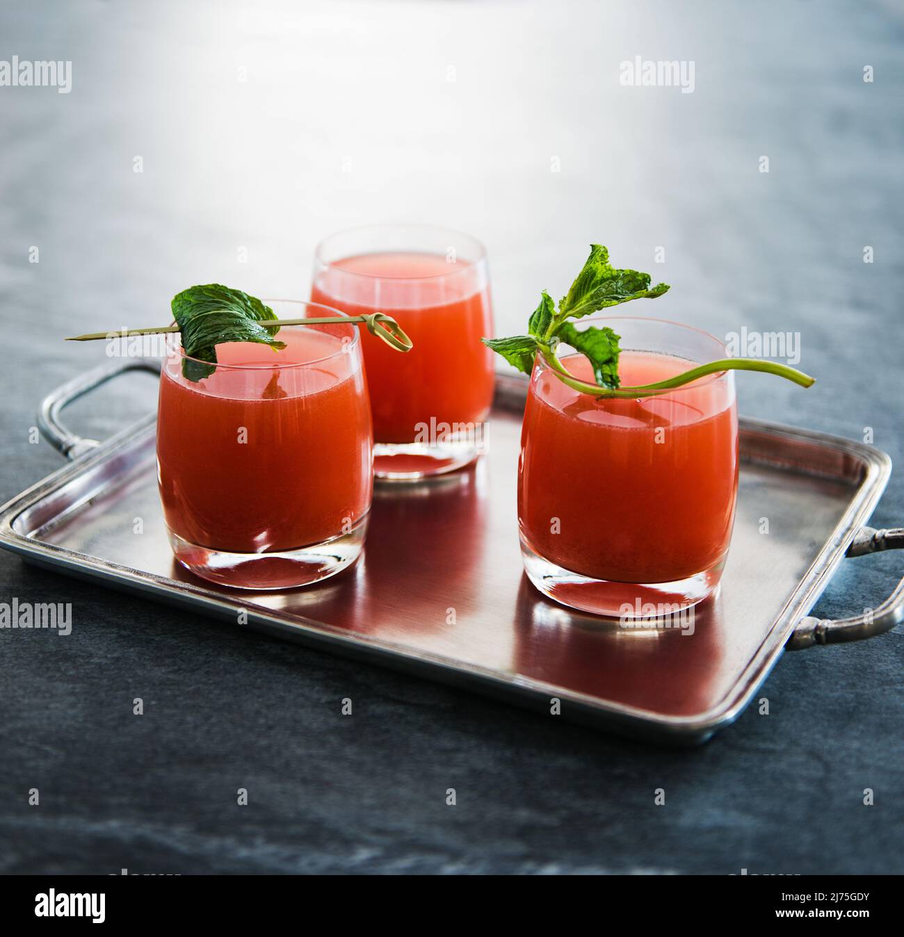 Watermelon rum cocktails garnished with mint Stock Photo Alamy