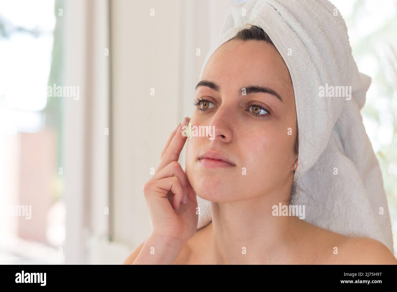 Young Beautiful Girl After Showering with Towel on Head in Bathroom