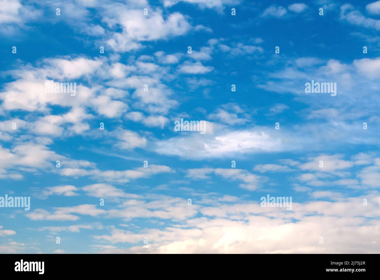 Defocus blue sky background with tiny white clouds. Panorama blue sky background with clouds. Abstract blurred piece background. Summer sky. Out of Stock Photo