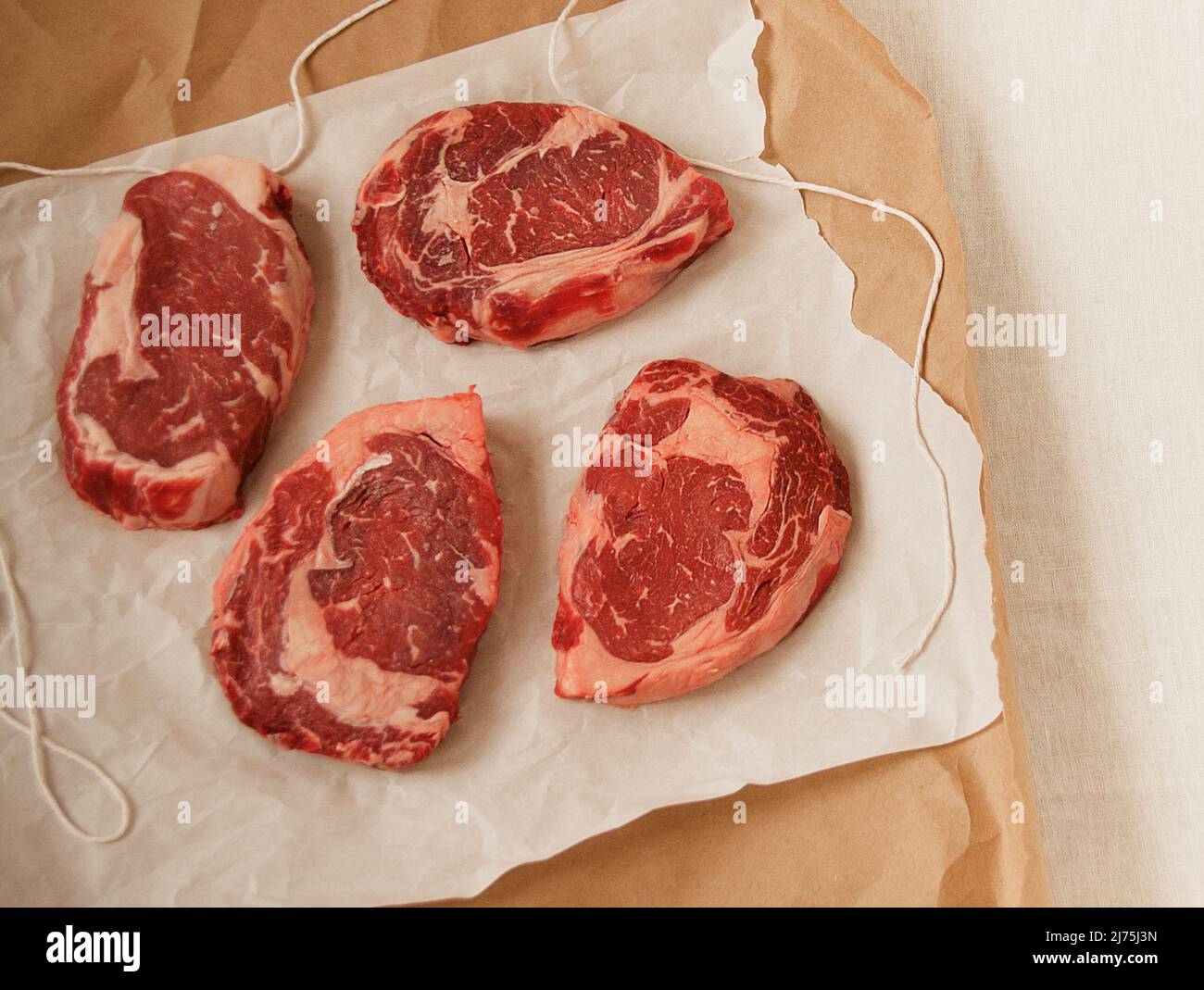 Aged rib eye steaks in butcher paper Stock Photo Alamy
