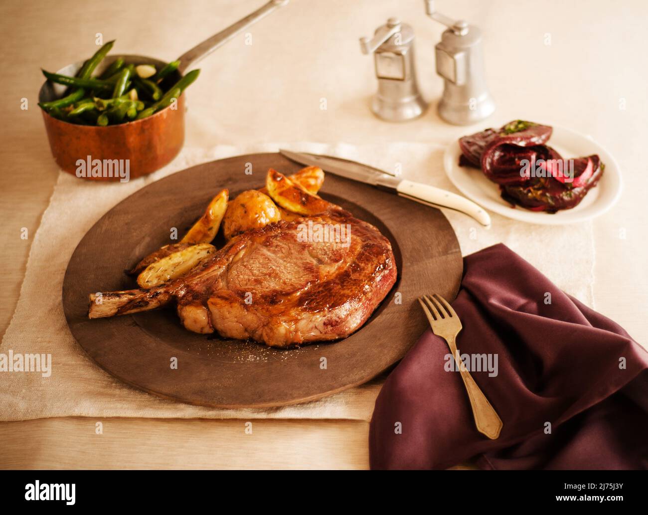 Dry Aged Frenched Prime Rib Chops with Green Beans, Roasted Potatoes and Beets Stock Photo