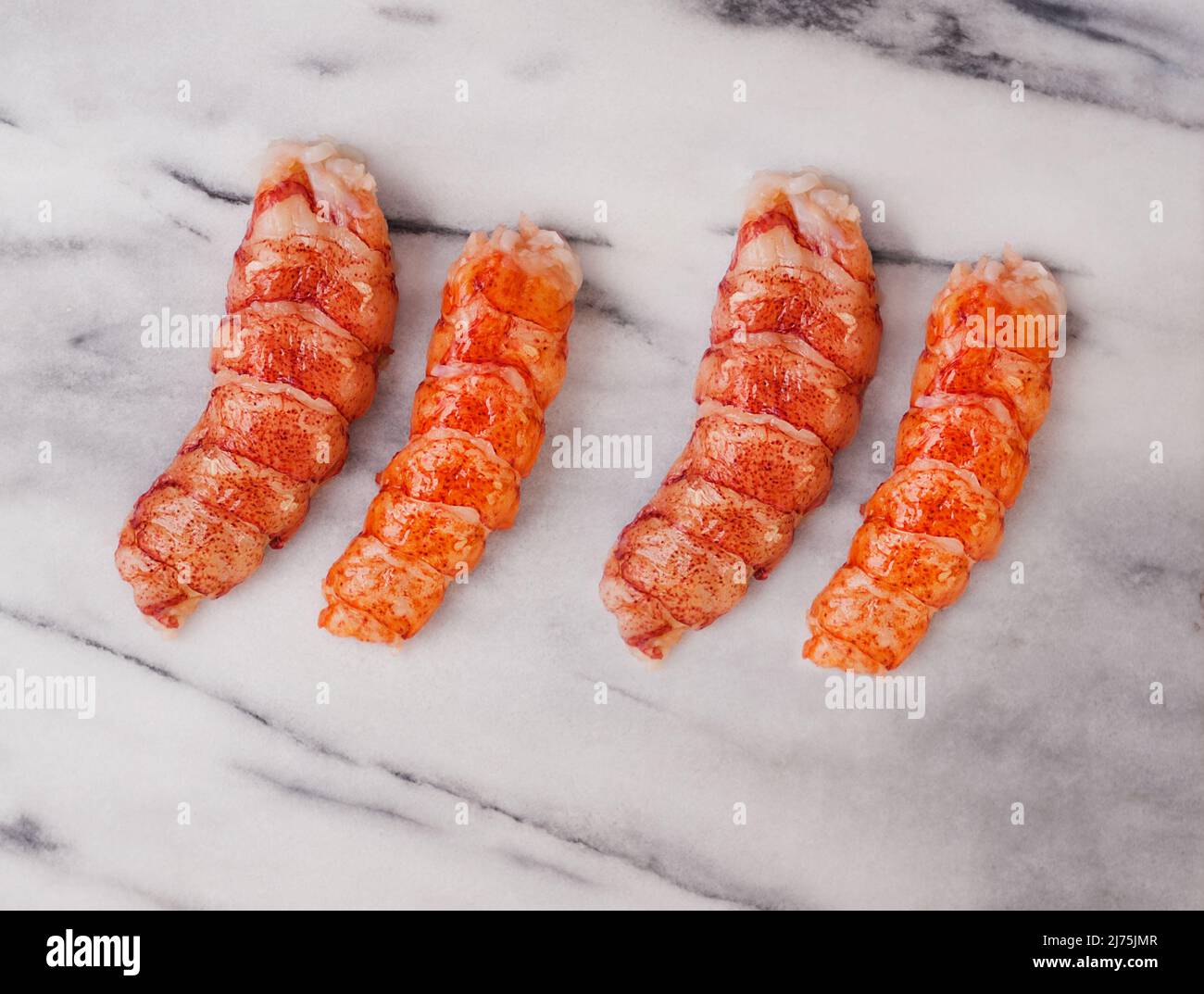 Lobster tails on marble Stock Photo