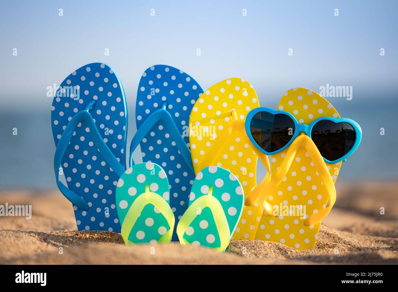 Beach flip-flops on the sand against sea and sky background. Summer ...