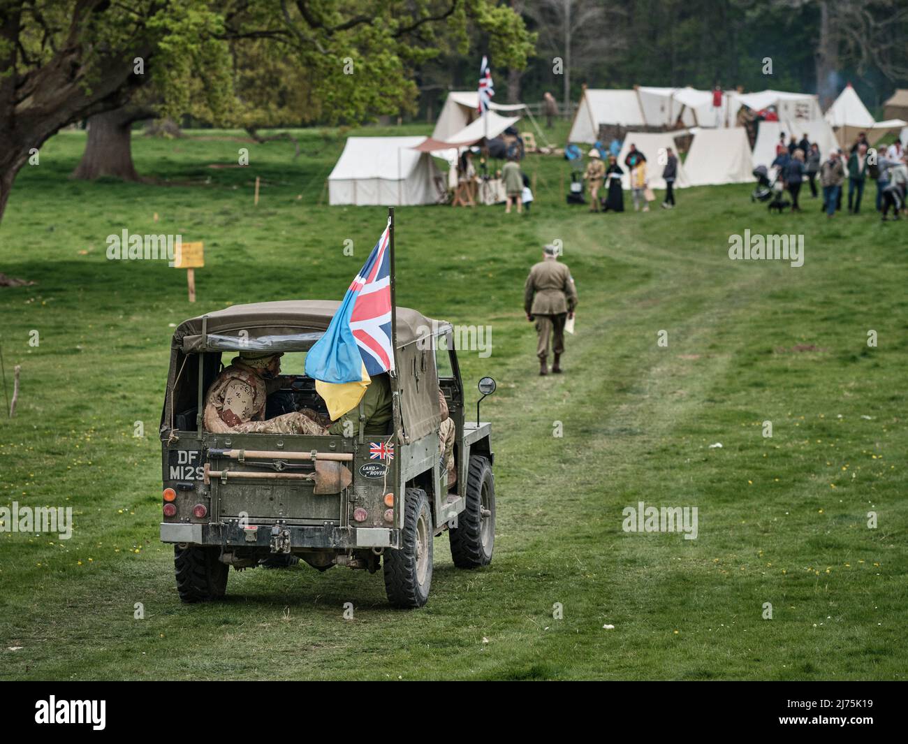 A vintage military Land Rover gives some soldiers a lift at the No Man's Land Event at Bodrhyddan Hall, Wales Stock Photo