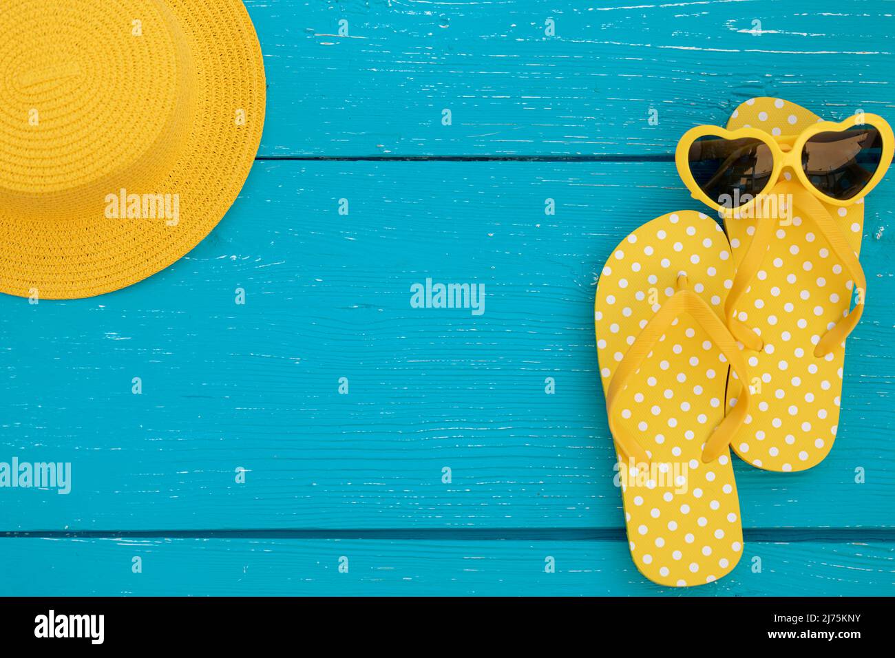 Beach flip-flops and sunglasses on blue wooden background. Summer ...